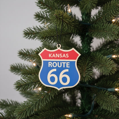 Kansas Route 66 wooden ornament hanging on a Christmas tree with warm lights, vintage highway sign holiday ornament for Route 66 travelers and souvenir collectors