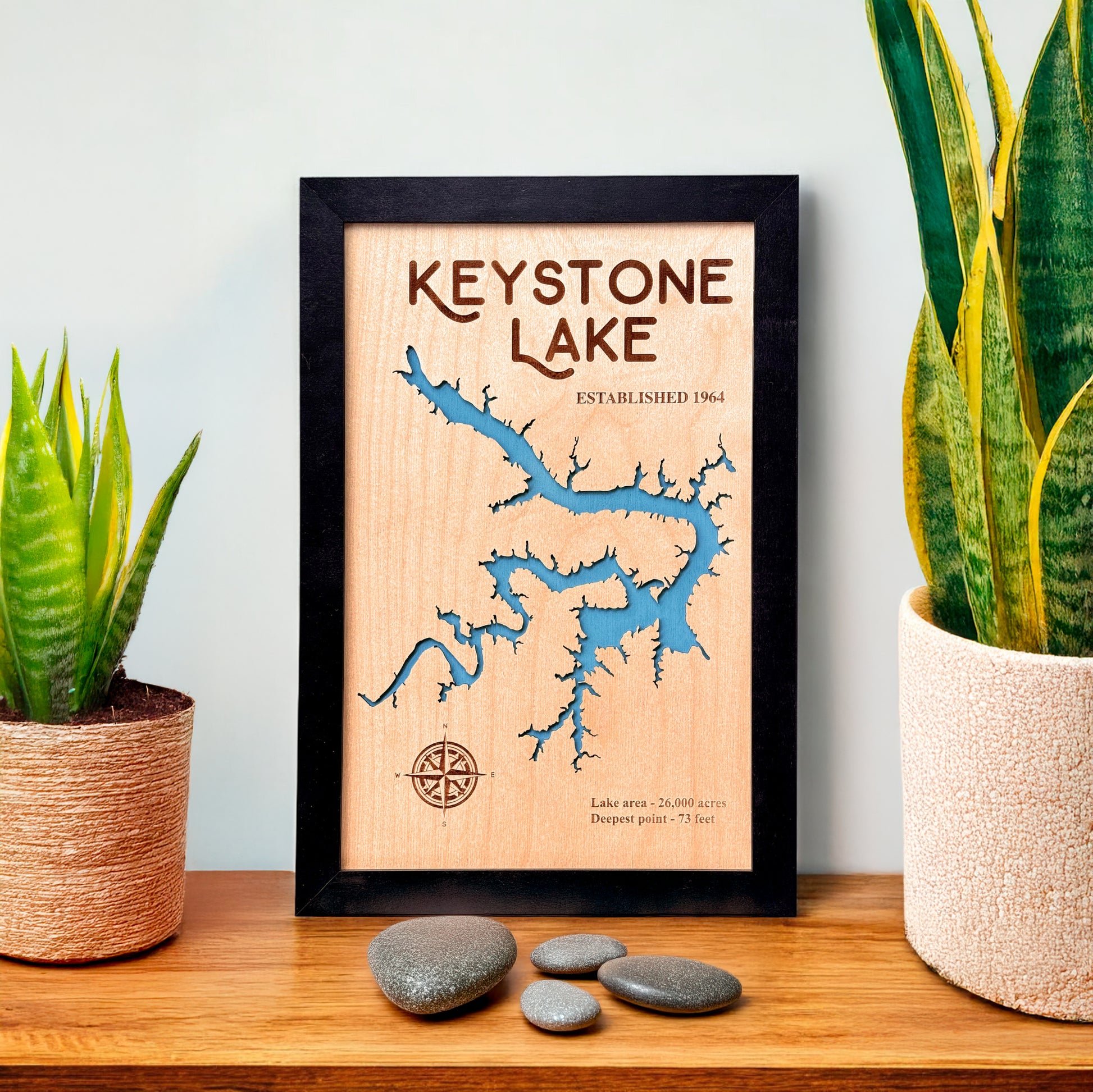 Keystone Lake framed wooden map displayed on shelf with plants, laser cut lake map wall art for lake house or cabin decor