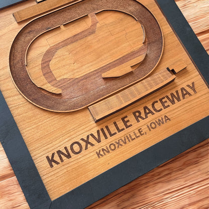 Close up of Knoxville Raceway wooden track map showing engraved lettering and layered oval track details, laser cut wood racing wall art made in the USA