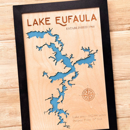 Close up angled view of Lake Eufaula wooden map showing laser cut shoreline, engraved text, and blue layered water detail