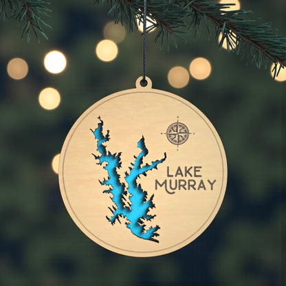 Lake Murray wooden ornament hanging on evergreen tree with lights, layered wood lake map ornament with blue painted water detail and hanging cord