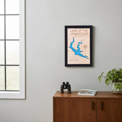 Framed Lake of the Arbuckles layered wood map hanging on a gray wall with natural light, showcasing Oklahoma lake art perfect for home or cabin decor.