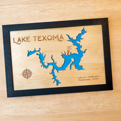 Close up of Lake Texoma wood map showing blue lake backing and engraved compass rose