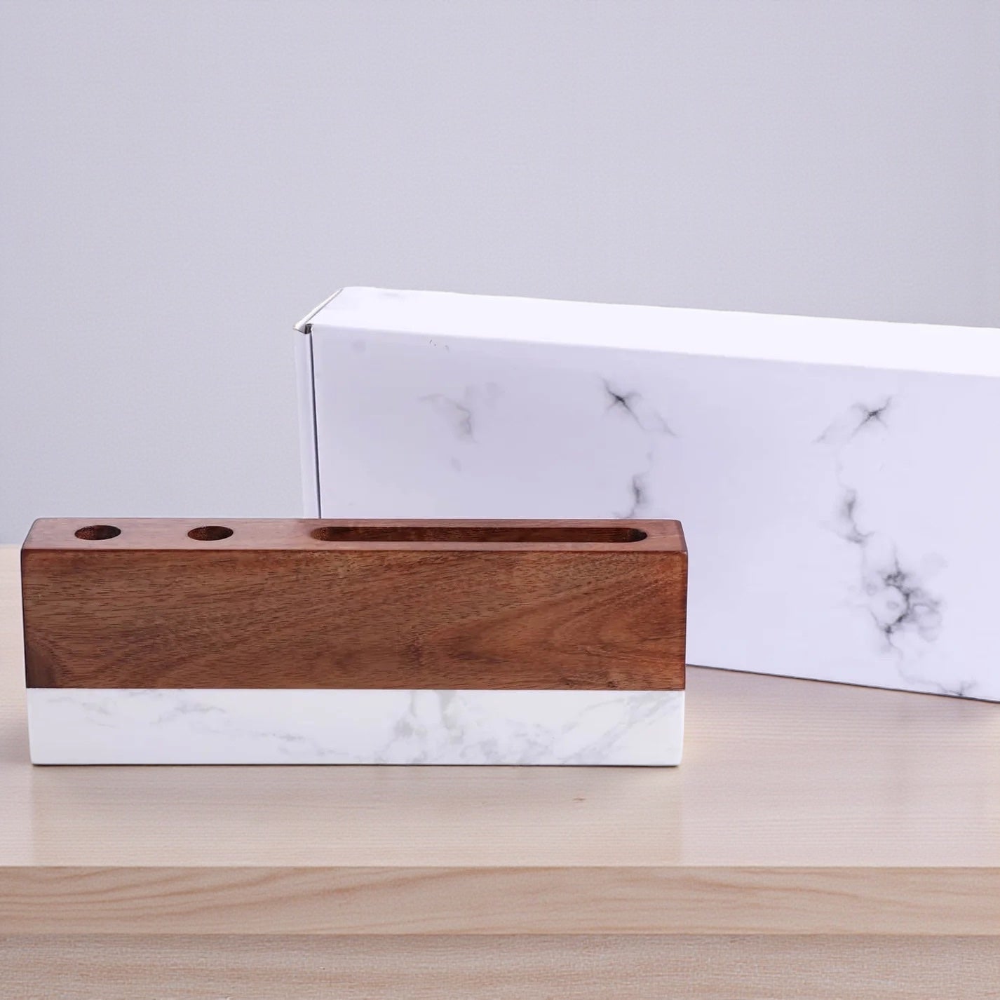 Marble desk name plate with acacia wood top displayed in front of white marble style gift box packaging, professional engraved office name plate gift