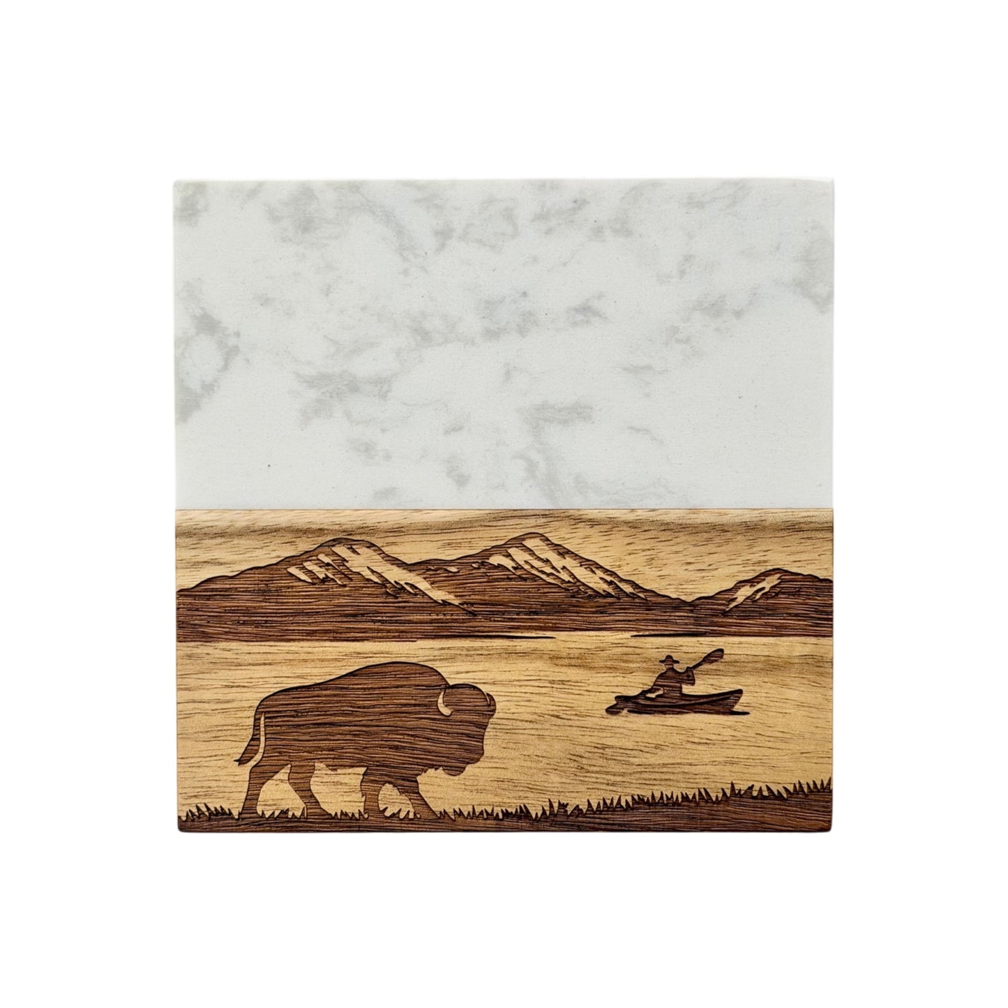 Front view of marble and wood coaster engraved with mountain scenery, lake water, bison silhouette, and kayaking scene for nature inspired home decor or travel souvenir