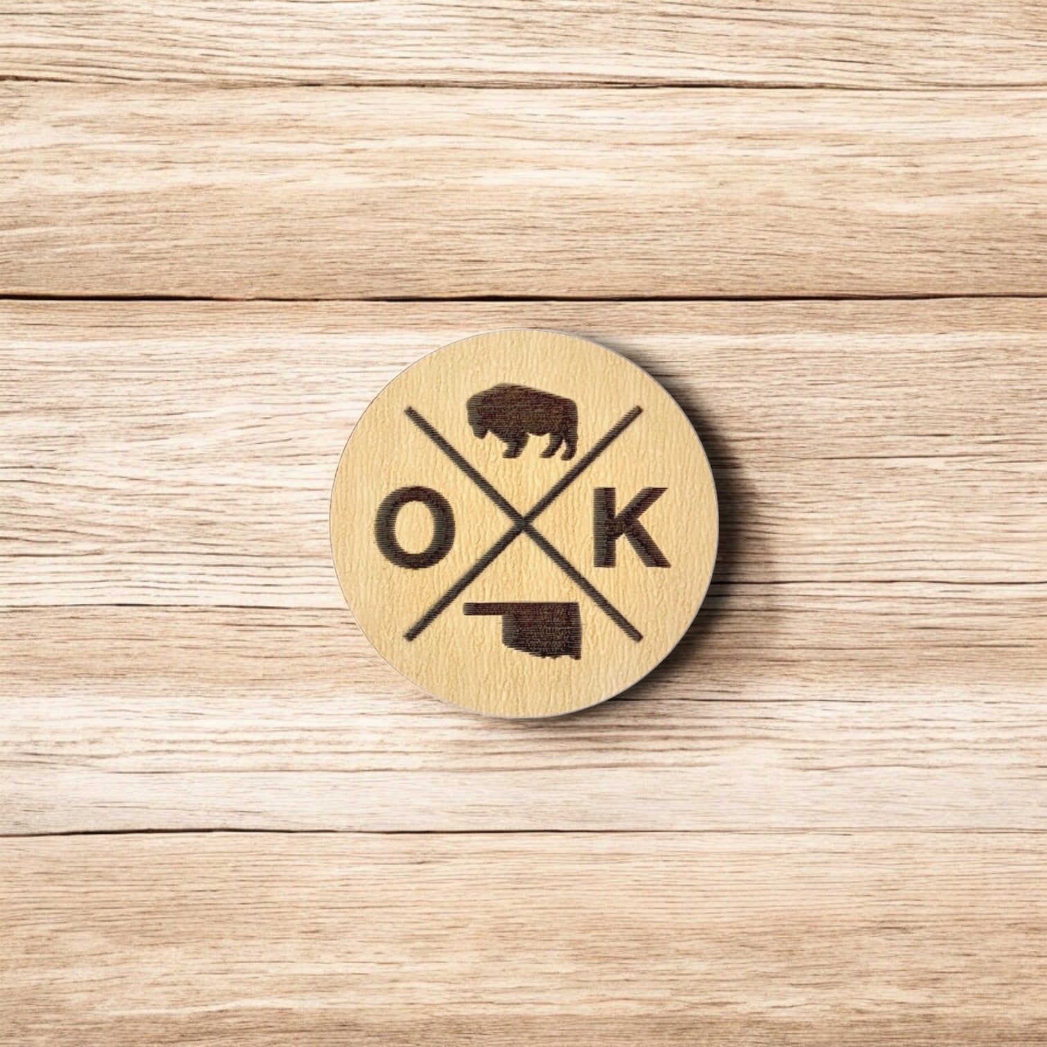 Back of OK wooden pin showing metal post and black rubber pin back, lightweight round wood lapel pin for hats and jackets