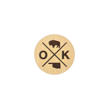 OK X wooden lapel pin showing engraved bison, OK lettering, and Oklahoma state outline, round laser cut wood pin designed as Oklahoma souvenir or state pride accessory