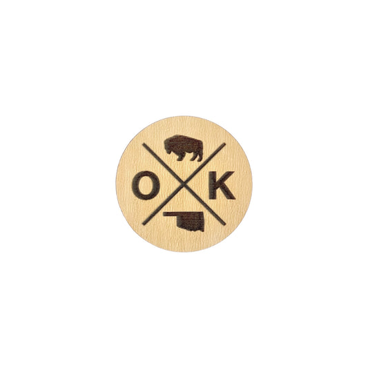 OK X wooden lapel pin showing engraved bison, OK lettering, and Oklahoma state outline, round laser cut wood pin designed as Oklahoma souvenir or state pride accessory