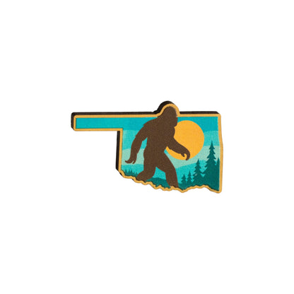 Eco Wood Birch Oklahoma Bigfoot lapel pin isolated on white background showing Sasquatch silhouette inside Oklahoma state outline with sunset design