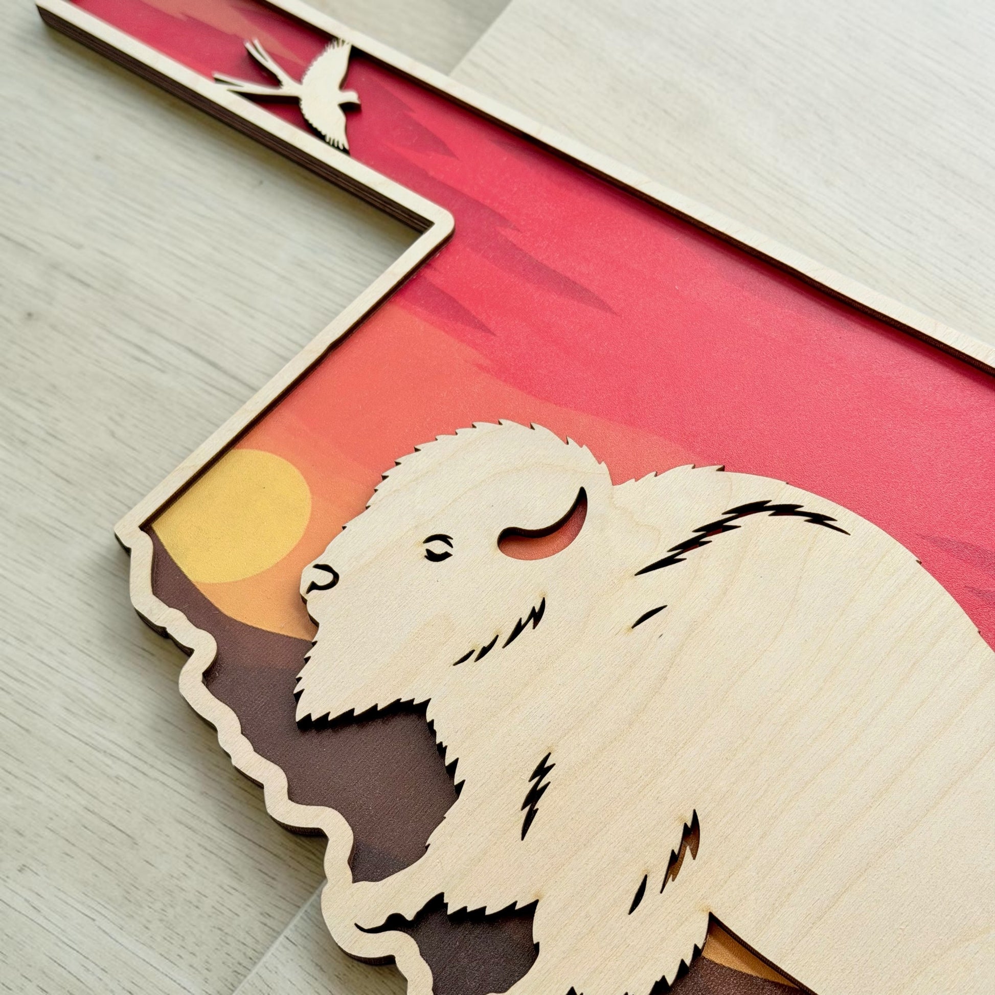 Closeup detail of Oklahoma bison sunset wall decor showing layered wood construction, prairie sunset landscape, and engraved bison details inspired by Oklahoma wildlife and Route 66 travel themes