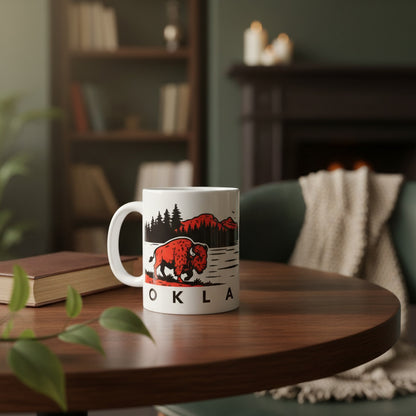 Oklahoma wildlife 11oz coffee mug with bison sunset design sitting on table in cozy home setting with a book, Oklahoma souvenir gift mug