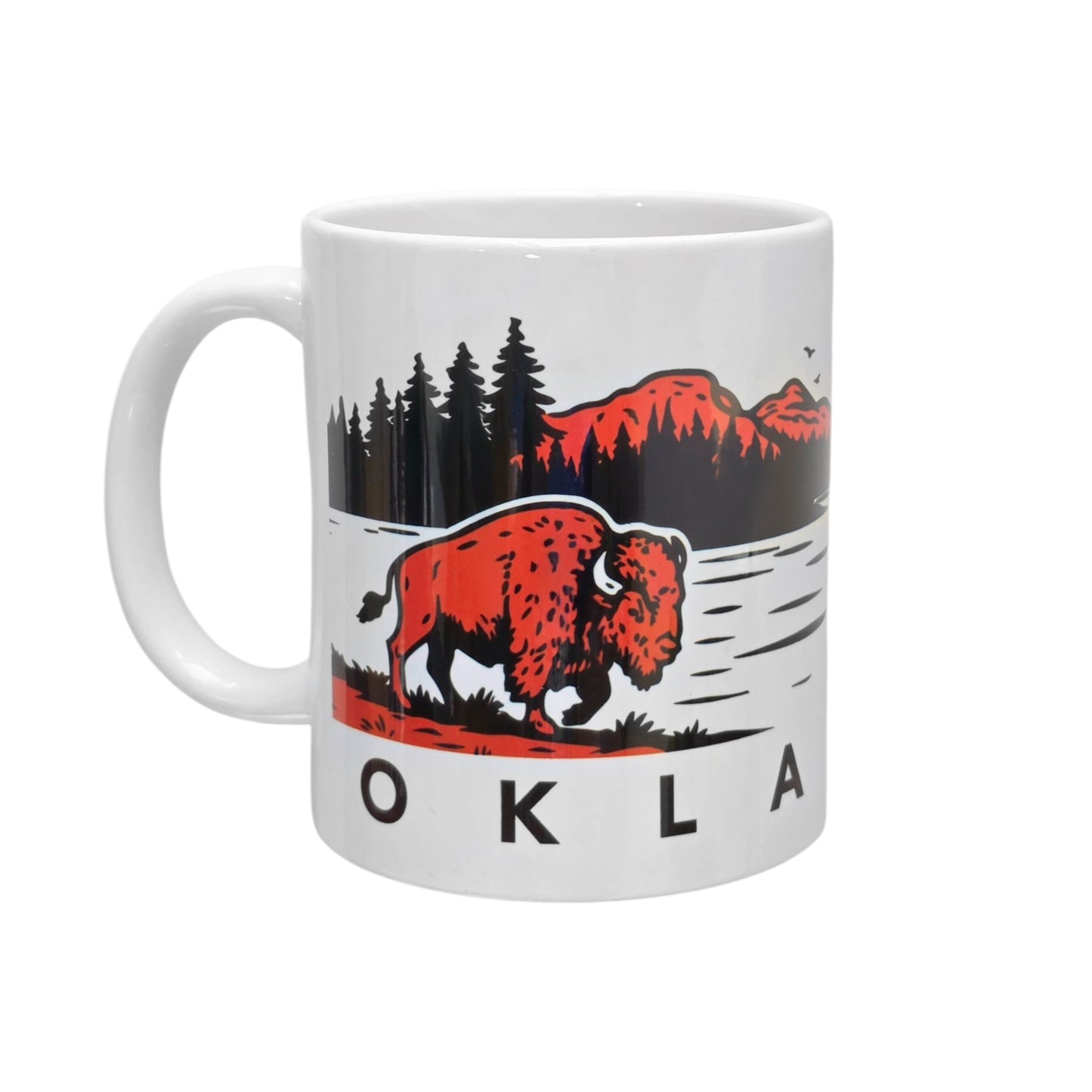 Oklahoma bison sunset ceramic 11oz coffee mug isolated on white background showing wildlife artwork with bison, trees, lake, and red mountain sunset