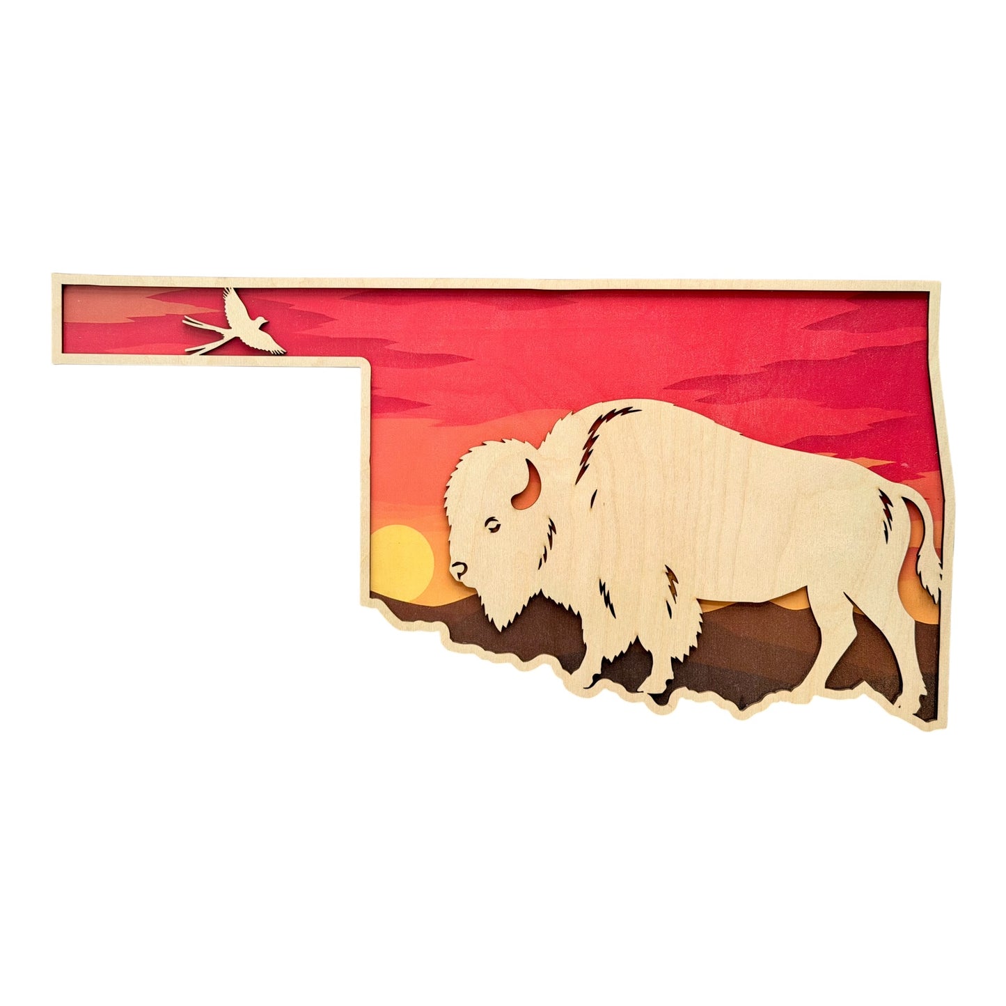 Layered Oklahoma shaped wood wall decor featuring a large American bison silhouette, prairie sunset landscape, and flying Scissortail Flycatcher with warm red and orange Oklahoma sunset colors