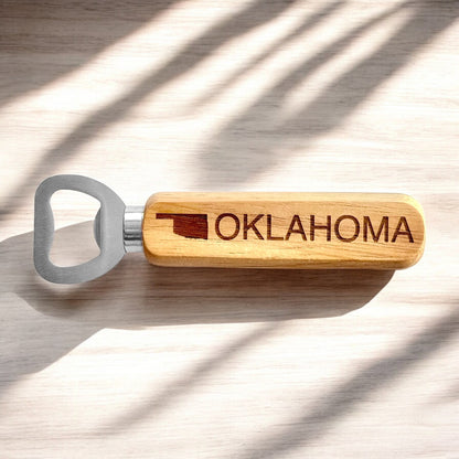 Oklahoma wooden bottle opener with engraved handle photographed on light wood surface, Oklahoma state souvenir and bar accessory