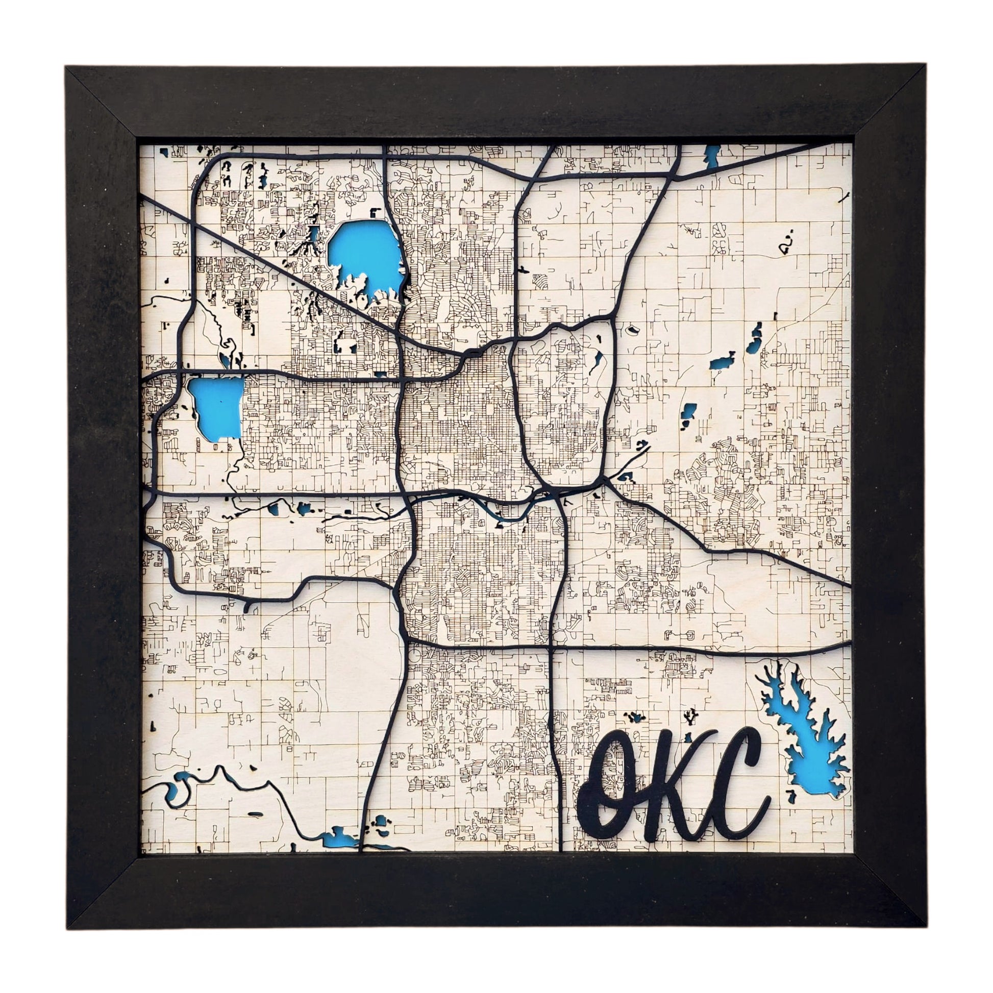 Close-up of Oklahoma City 3D wooden map showing detailed laser-cut streets and blue lake inlays, handmade OKC layered wood wall art by The Curious Bison.