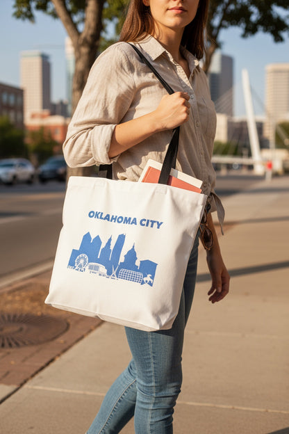 Oklahoma City skyline tote bag being carried outdoors, blue OKC skyline design on canvas tote used as everyday city bag