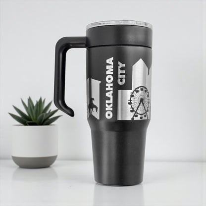 Black Oklahoma City skyline 30oz tumbler with handle attached showing engraved city skyline design, stainless steel Oklahoma City travel mug
