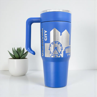Blue Oklahoma City skyline 30oz tumbler with handle attached, engraved skyline design on stainless steel travel mug