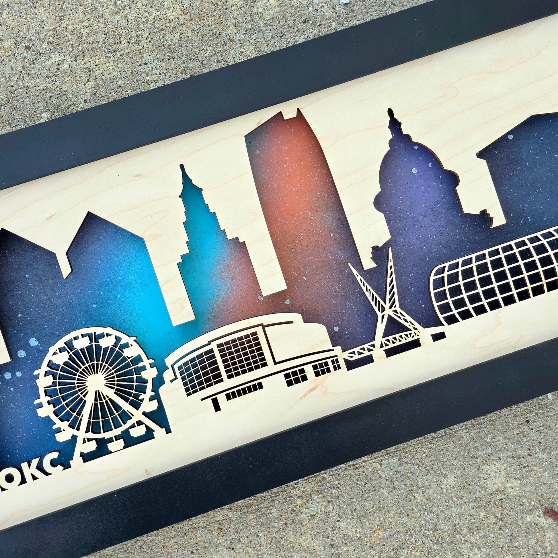 Close up of Oklahoma City skyline wooden wall art showing layered wood depth, laser cut landmark detail, and painted night background