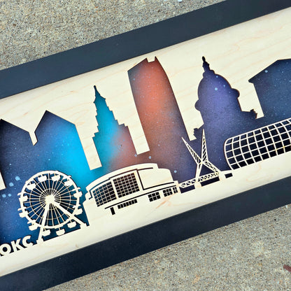 Close up of Oklahoma City skyline wooden wall art showing layered wood depth, laser cut landmark detail, and painted night background