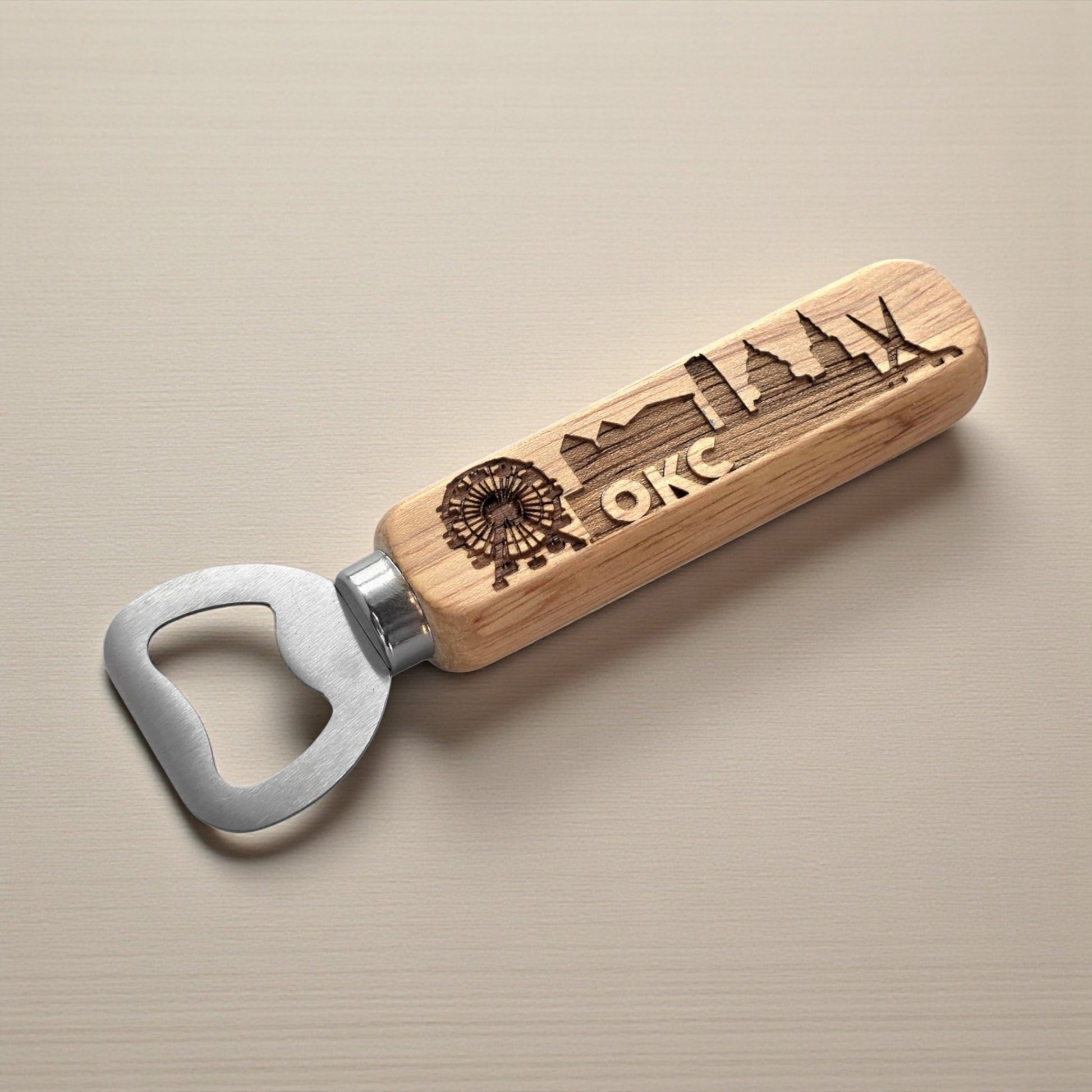 Oklahoma City skyline bottle opener with laser-engraved wood handle and metal head, perfect Route 66 bar accessory by The Curious Bison.