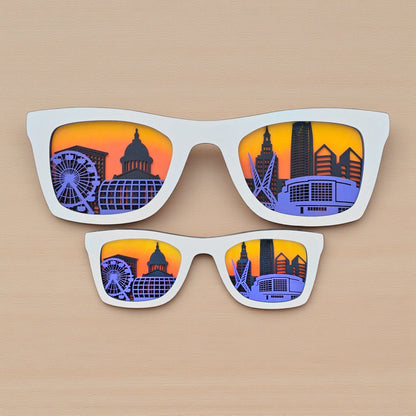White Oklahoma City skyline sunglasses wall art showing layered downtown skyline design inside sunglasses shape, Oklahoma City souvenir decor