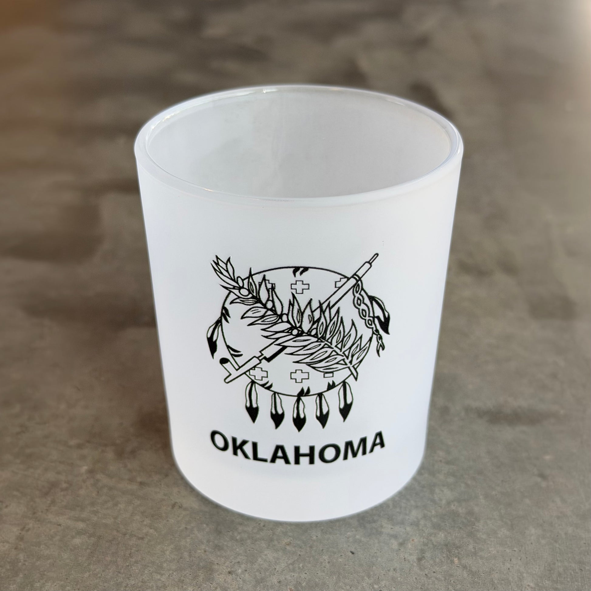 Frosted Oklahoma rocks glass displayed on a countertop featuring UV printed Oklahoma state flag inspired artwork, home bar accessory and Oklahoma souvenir.