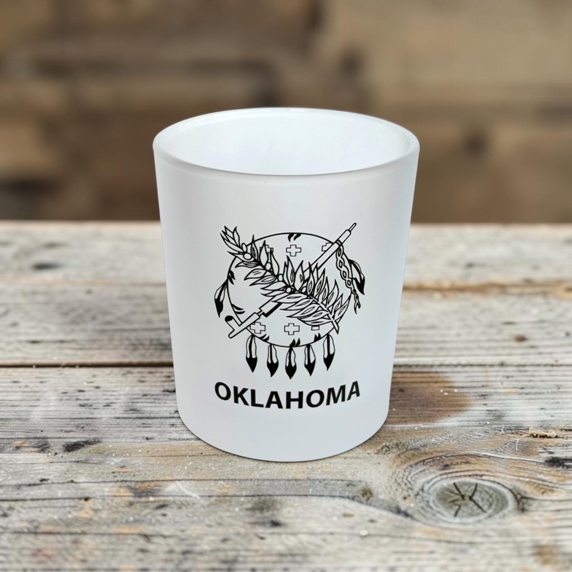 Frosted Oklahoma 8 oz whiskey rocks glass with Oklahoma state flag inspired design displayed on a rustic wood table, ideal as an Oklahoma souvenir, whiskey gift, or Route 66 keepsake.