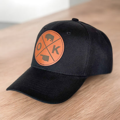 Angled view of black Oklahoma leatherette patch baseball hat, Oklahoma souvenir and travel gift