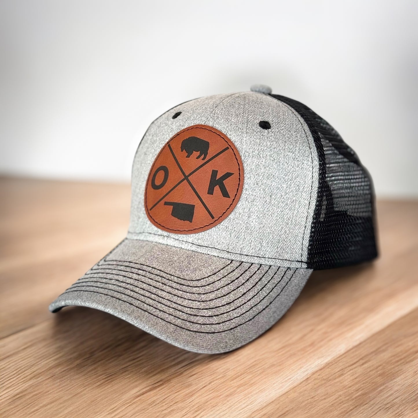 Angled view of gray Oklahoma leatherette patch snapback hat showing OK bison design, travel friendly souvenir