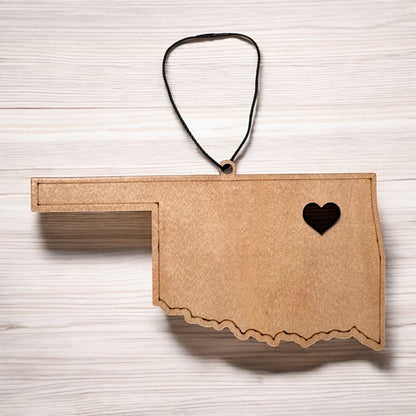 Flat lay of Oklahoma heart wooden ornament showing state outline and heart cutout, minimalist Oklahoma ornament made from wood