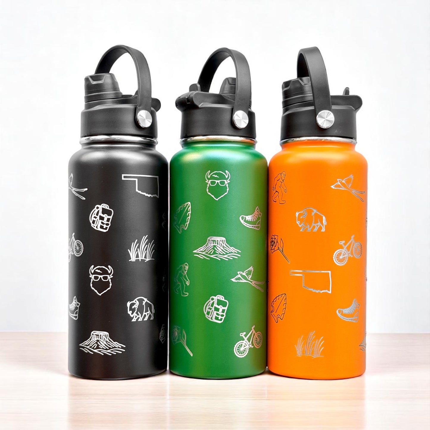 Set of black green and orange Oklahoma icons 32oz insulated water bottles with laser engraved state symbols and dual lid design