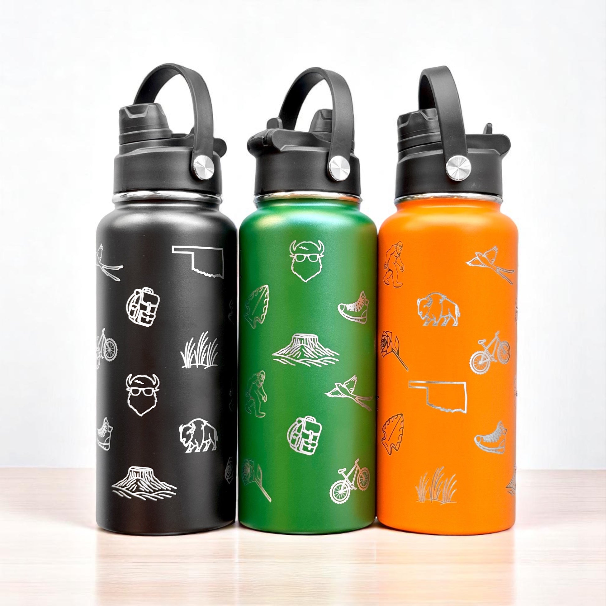 Set of black green and orange Oklahoma icons 32oz insulated water bottles with laser engraved state symbols and dual lid design