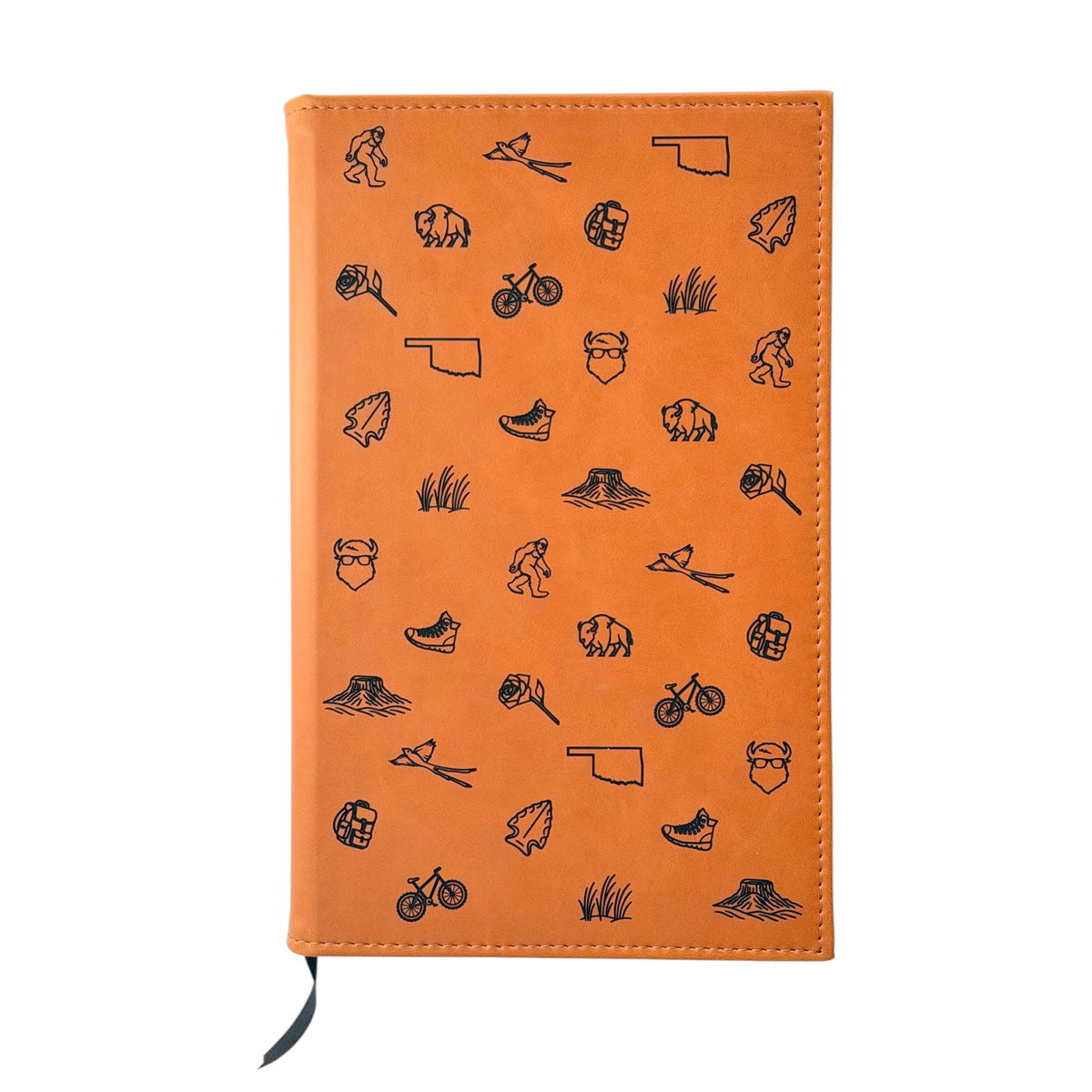 Tan Oklahoma leatherette journal with engraved bison, scissortail, Oklahoma state outline and outdoor icons on the front cover, lined notebook and Oklahoma gift