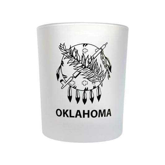 Angled view of an 8 oz frosted Oklahoma lowball whiskey glass with Oklahoma state flag inspired artwork, perfect for bourbon, scotch, cocktails, and Oklahoma gift giving.