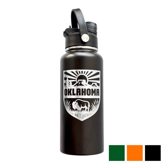 Black 32oz insulated stainless steel water bottle with laser engraved Oklahoma outdoor adventure shield design featuring bison prairie grass and rising sun