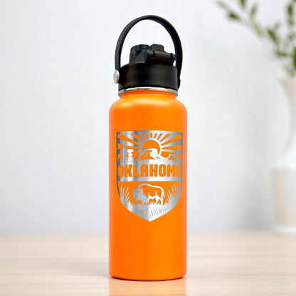 Orange Oklahoma outdoor adventure insulated water bottle with engraved bison and landscape shield design