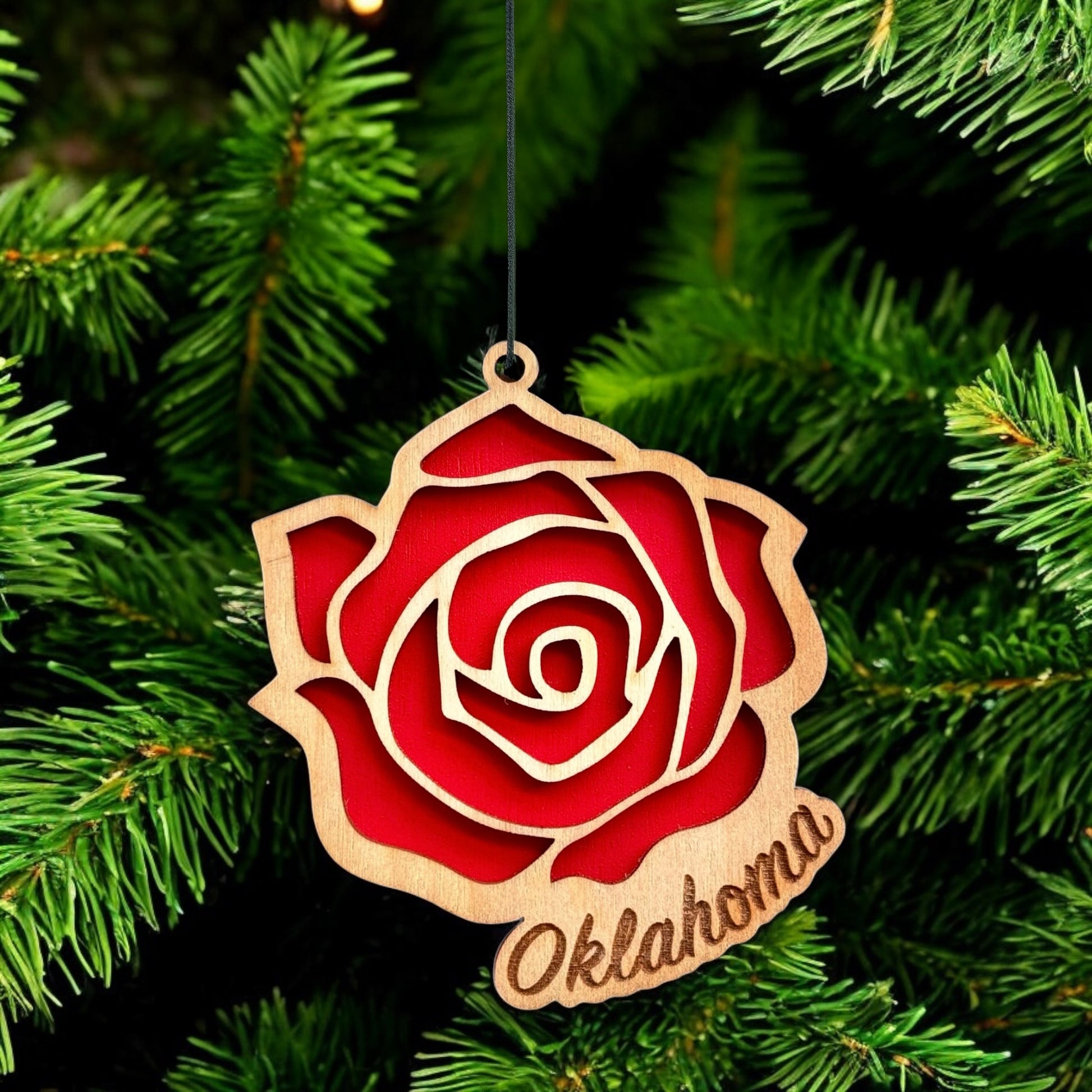 Oklahoma rose wooden ornament hanging on evergreen tree, layered wood state flower ornament used as Oklahoma Christmas decor
