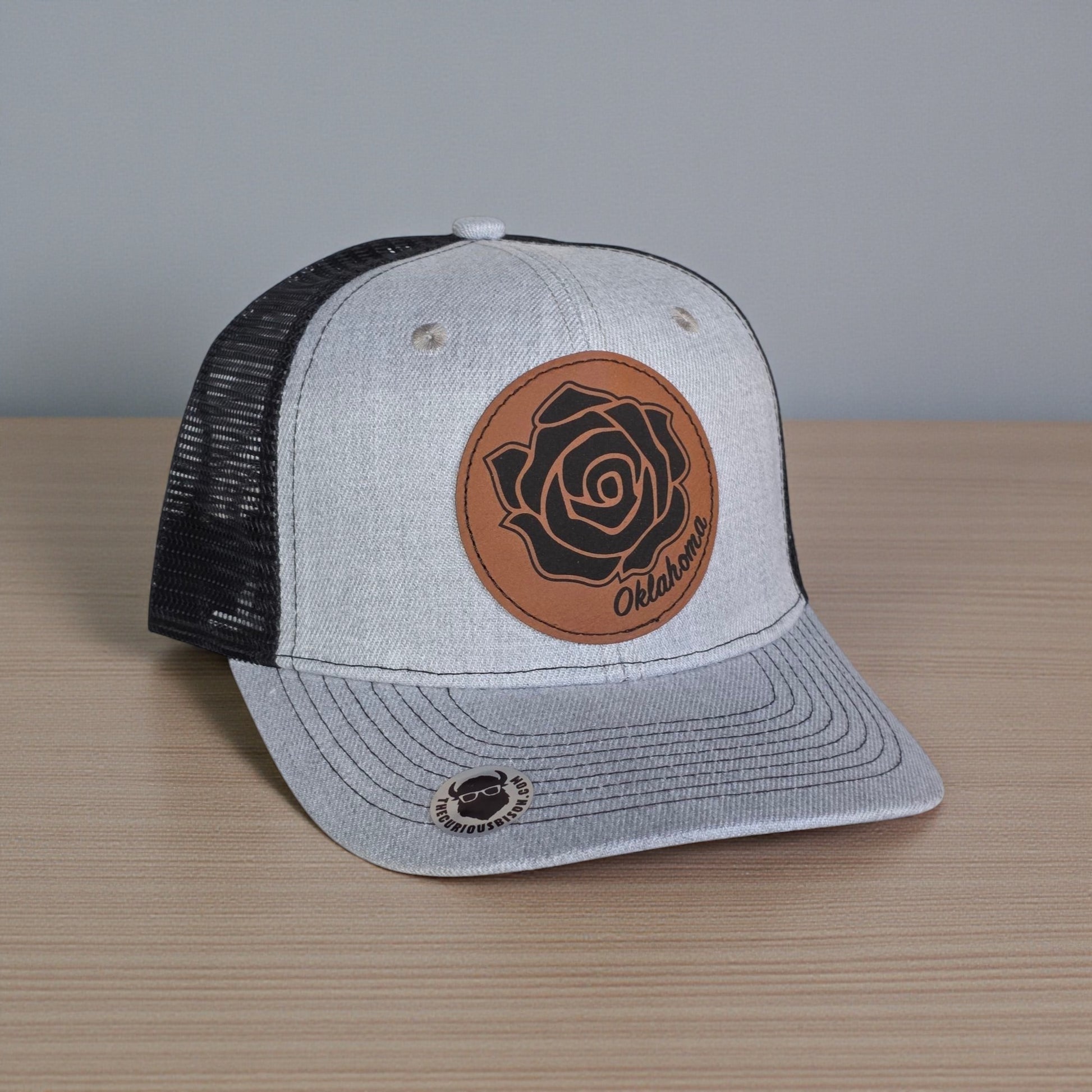 Angled view of Oklahoma Rose Rock trucker hat showing leatherette patch, mesh back, and curved brim, Oklahoma gift hat for everyday wear