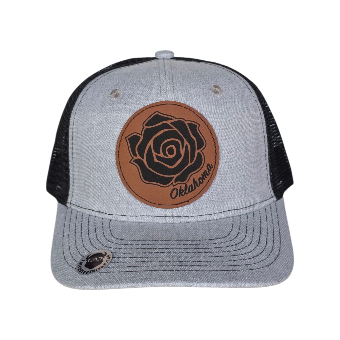 Front view of Oklahoma Rose Rock trucker hat with laser engraved leatherette patch featuring rose rock floral design, casual Oklahoma souvenir hat