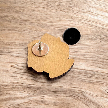 Back of Oklahoma rose wooden pin showing metal post and black rubber pin back, laser cut wood lapel pin for hats and jackets