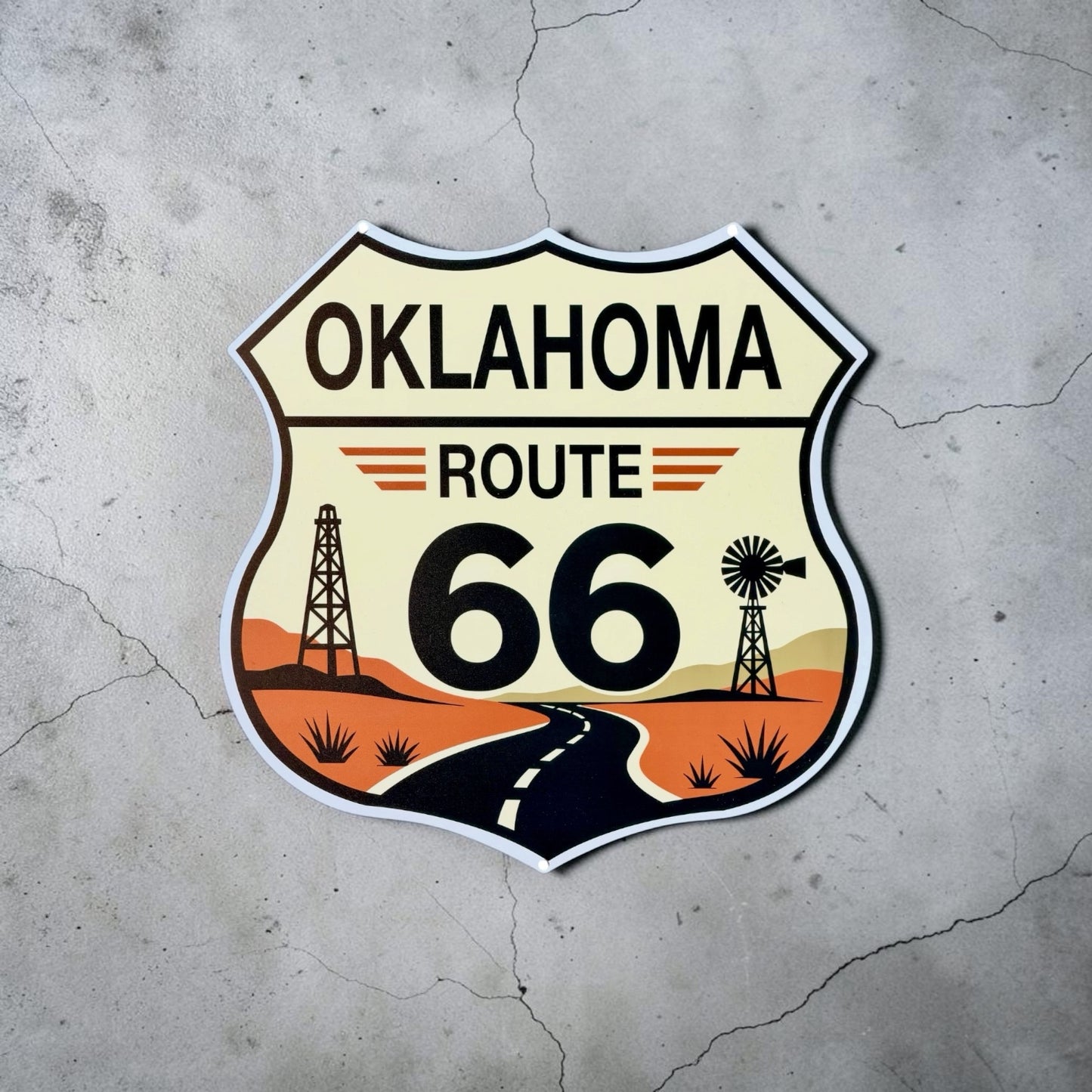 Oklahoma Route 66 metal wall sign displayed on a concrete wall showing vintage inspired Route 66 shield artwork with highway, desert scenery, oil derrick, and windmill. Decorative metal sign for Route 66 collectors, Oklahoma souvenirs, garage decor, and travel themed spaces.