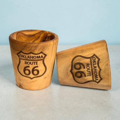Two Oklahoma Route 66 olive wood shot glasses showing natural wood grain variations and laser engraved highway shields, Route 66 road trip souvenir drinkware