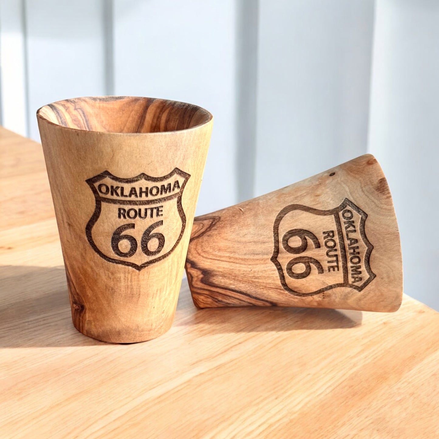 Two olive wood shot glasses engraved with Oklahoma Route 66 shield, natural wood grain Route 66 souvenir shot glasses