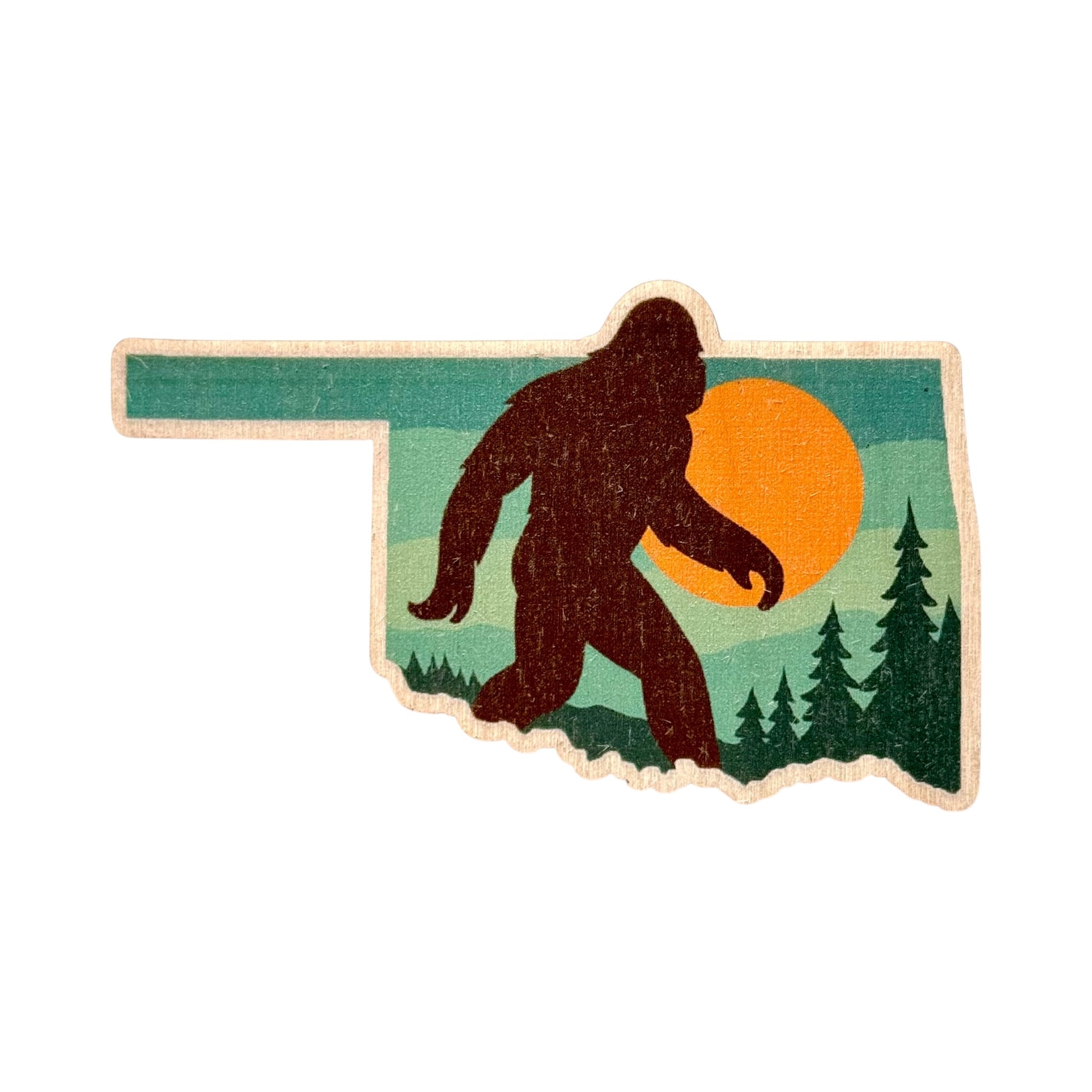 Oklahoma state shape wooden veneer sticker featuring Sasquatch silhouette walking through pine trees with sunset background, real wood Oklahoma sticker for travel or souvenir use