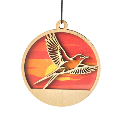 Oklahoma scissor-tailed flycatcher wooden ornament with layered wood bird design over a sunset background, round Oklahoma ornament with hanging cord for state pride gift or souvenir