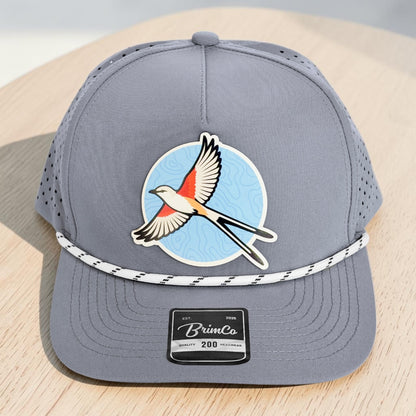 Close angled view of gray performance rope hat with Oklahoma scissor-tailed flycatcher patch, laser-perforated panels, structured crown, and stitched precurved bill