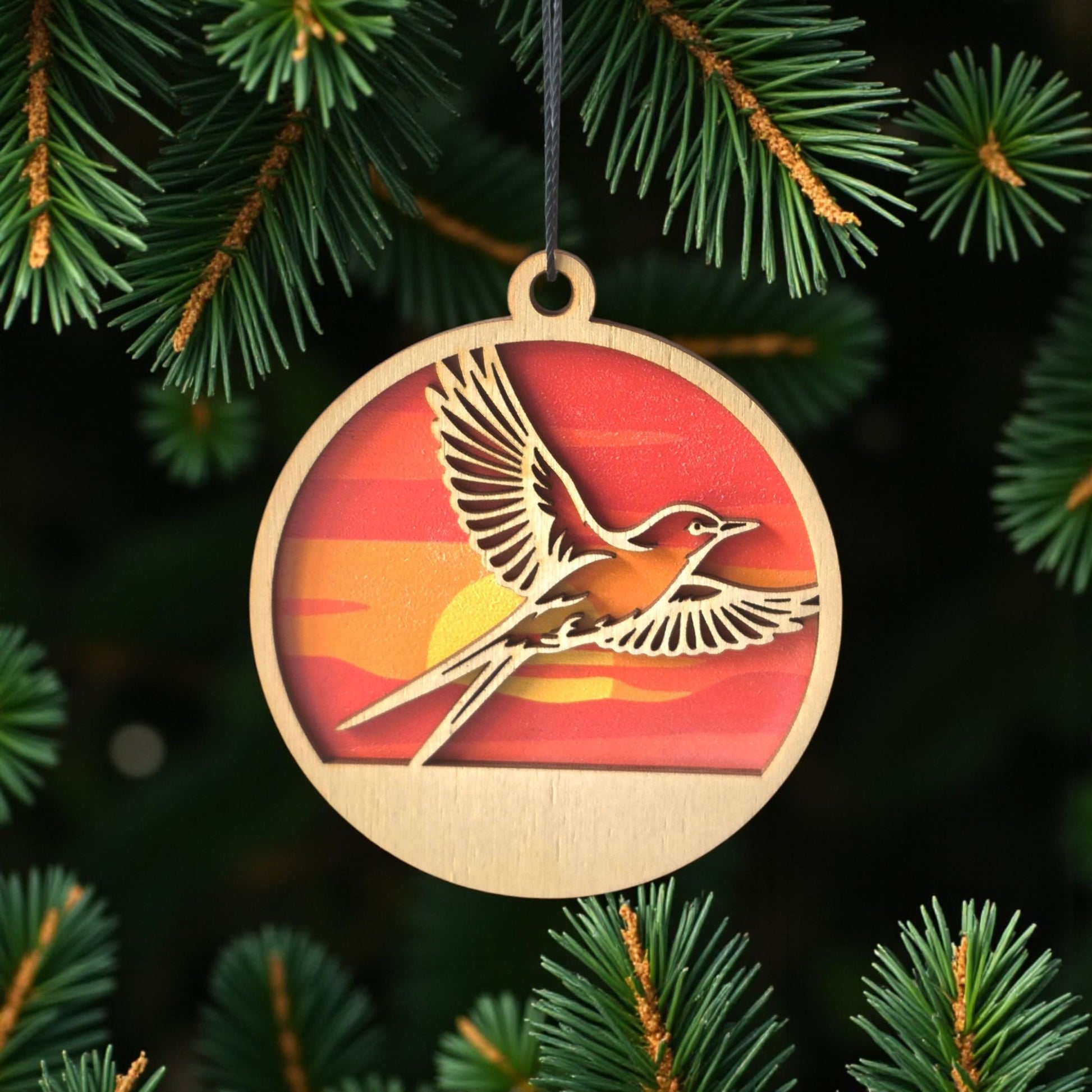  Oklahoma scissor-tailed flycatcher wooden ornament hanging on evergreen tree, layered wood state bird ornament used as Oklahoma Christmas decor or souvenir