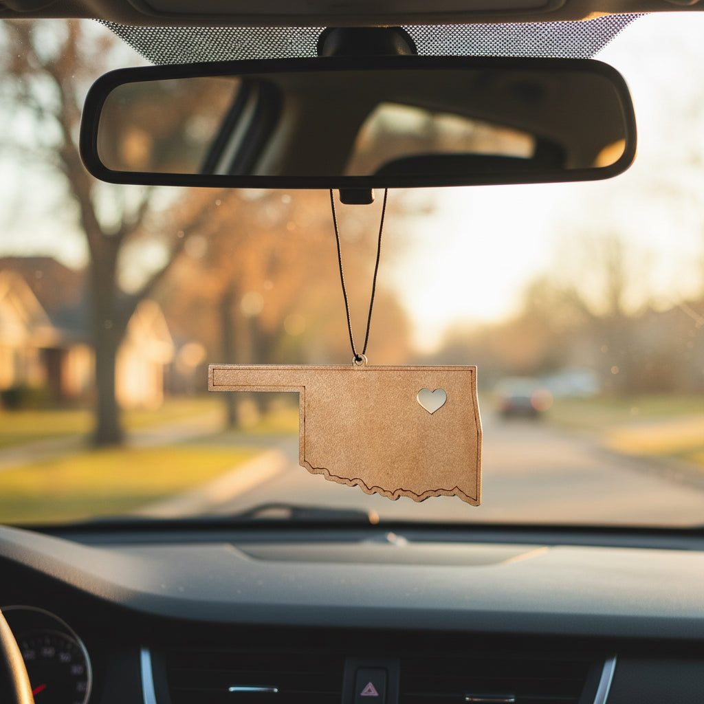Wooden Oklahoma state heart car ornament hanging from rearview mirror, laser cut state shape with small heart cutout marking home, lightweight auto accessory gift for Oklahoma locals, Route 66 travelers, and USA state souvenir collectors.