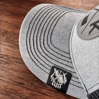 Aluminum Oklahoma symbol hat clip attached to the brim of a gray hat, square black clip with engraved design